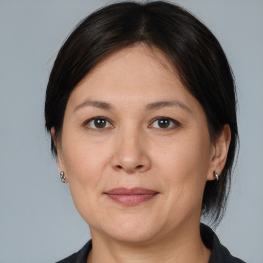 Joyful white adult female with medium  brown hair and brown eyes