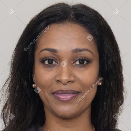 Joyful black young-adult female with long  brown hair and brown eyes
