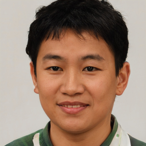 Joyful asian young-adult male with short  brown hair and brown eyes