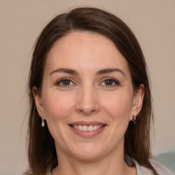 Joyful white adult female with medium  brown hair and brown eyes