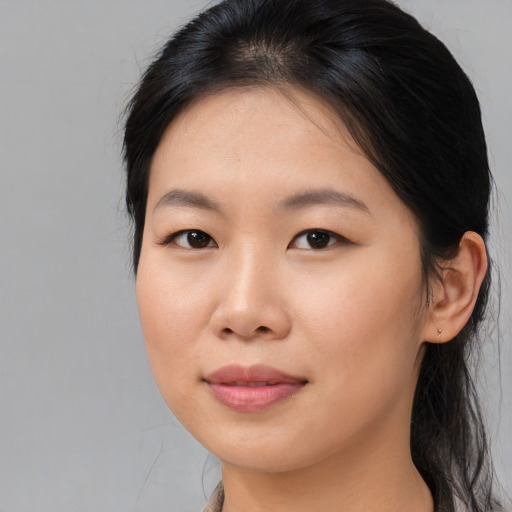 Joyful asian young-adult female with medium  brown hair and brown eyes