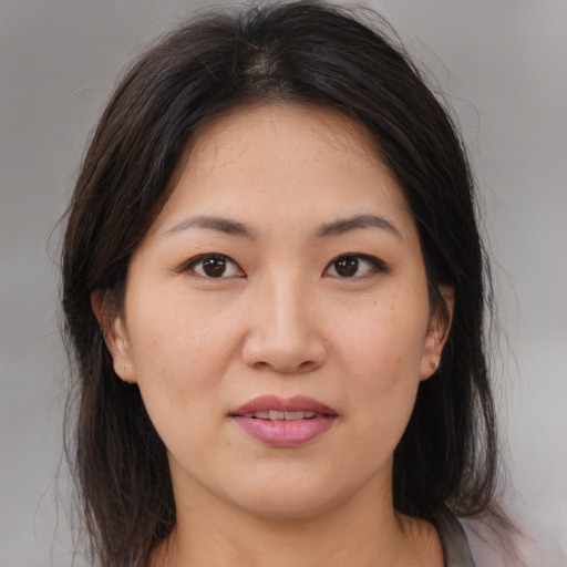 Joyful asian young-adult female with medium  brown hair and brown eyes