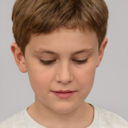 Joyful white child male with short  brown hair and brown eyes