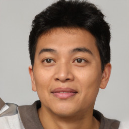 Joyful asian young-adult male with short  brown hair and brown eyes