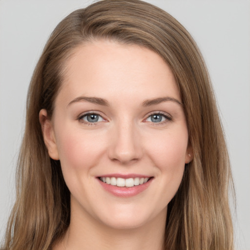 Joyful white young-adult female with long  brown hair and grey eyes