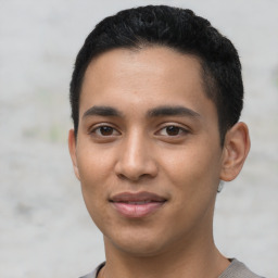 Joyful latino young-adult male with short  black hair and brown eyes