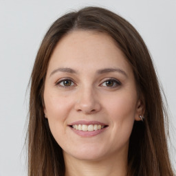 Joyful white young-adult female with long  brown hair and grey eyes