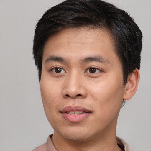 Joyful asian young-adult male with short  brown hair and brown eyes