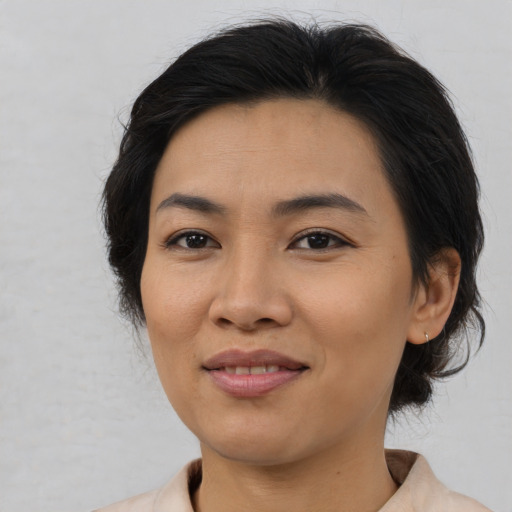 Joyful asian young-adult female with medium  brown hair and brown eyes
