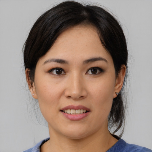Joyful asian young-adult female with medium  black hair and brown eyes