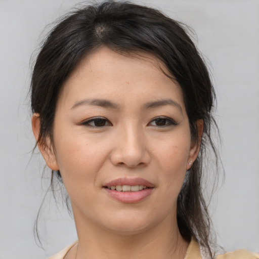 Joyful asian young-adult female with medium  brown hair and brown eyes