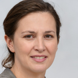 Joyful white adult female with short  brown hair and grey eyes