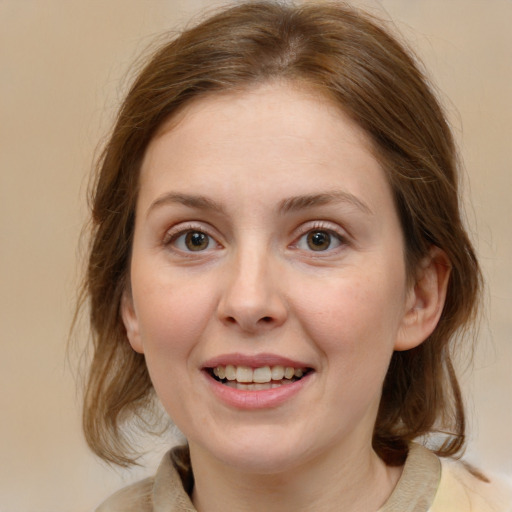 Joyful white young-adult female with medium  brown hair and blue eyes