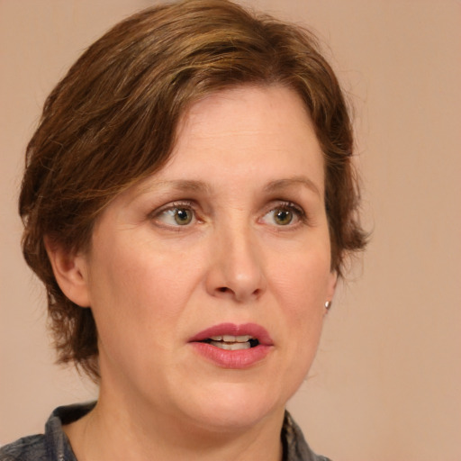 Joyful white adult female with medium  brown hair and green eyes