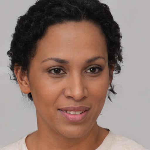 Joyful latino young-adult female with short  brown hair and brown eyes