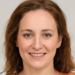 Joyful white young-adult female with long  brown hair and green eyes