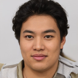 Joyful asian young-adult male with short  brown hair and brown eyes