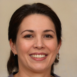 Joyful white adult female with medium  brown hair and brown eyes