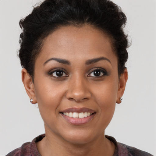Joyful latino young-adult female with short  brown hair and brown eyes
