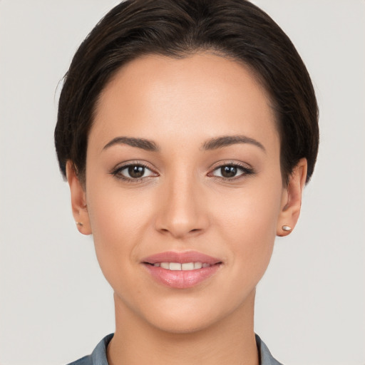 Joyful white young-adult female with short  brown hair and brown eyes