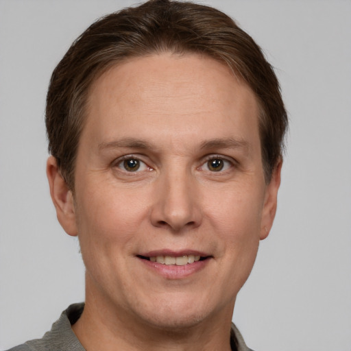 Joyful white adult male with short  brown hair and grey eyes