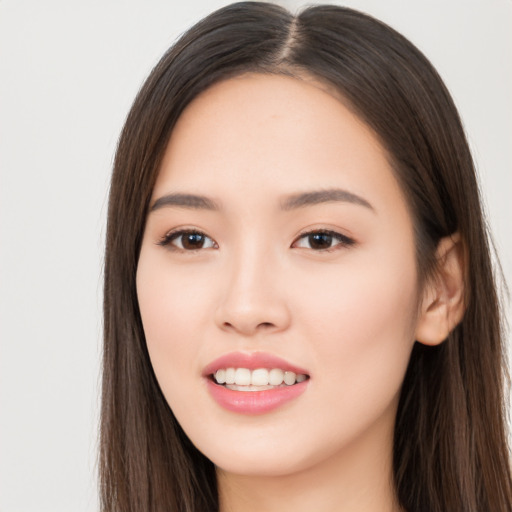 Joyful asian young-adult female with long  brown hair and brown eyes