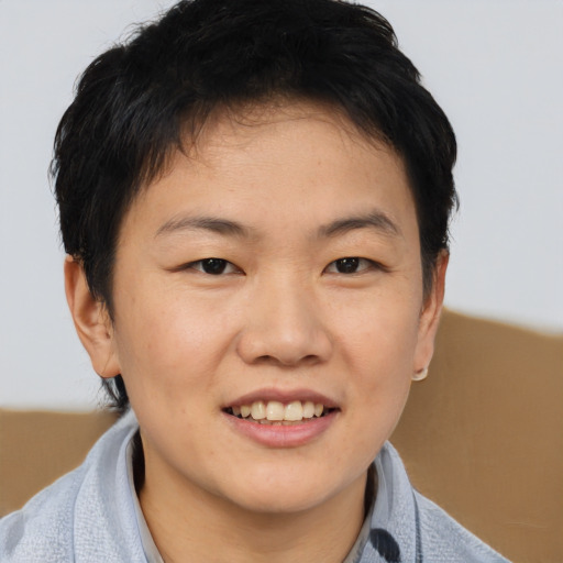 Joyful asian young-adult male with short  brown hair and brown eyes