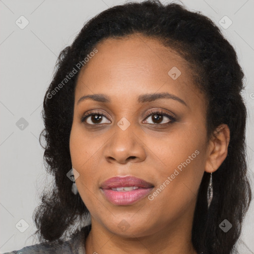 Joyful black young-adult female with long  brown hair and brown eyes