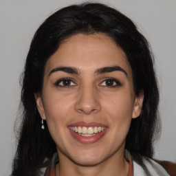 Joyful latino young-adult female with medium  brown hair and brown eyes