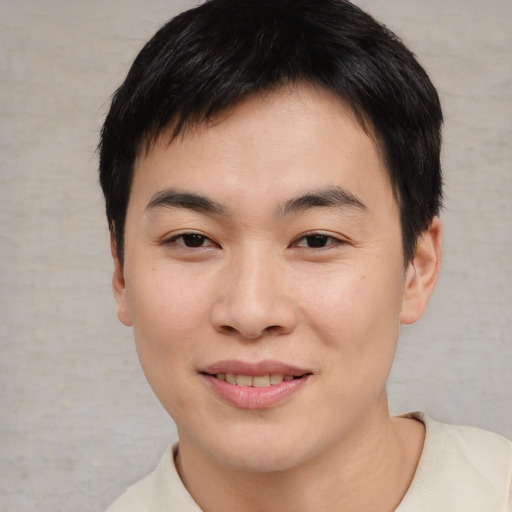 Joyful asian young-adult male with short  brown hair and brown eyes