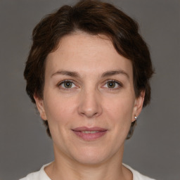 Joyful white adult female with short  brown hair and brown eyes