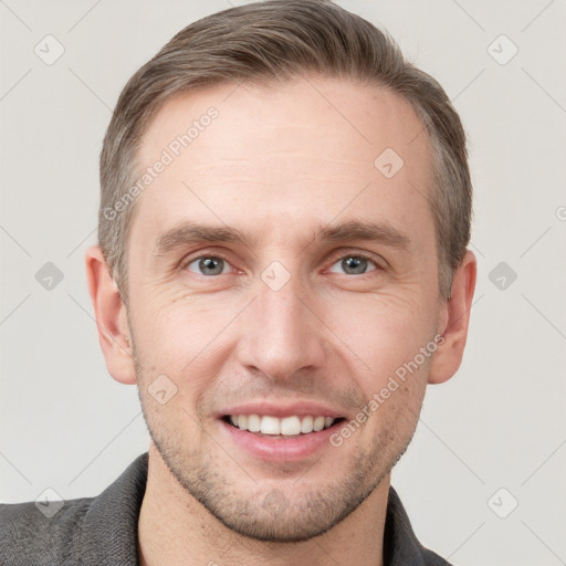 Joyful white young-adult male with short  brown hair and grey eyes