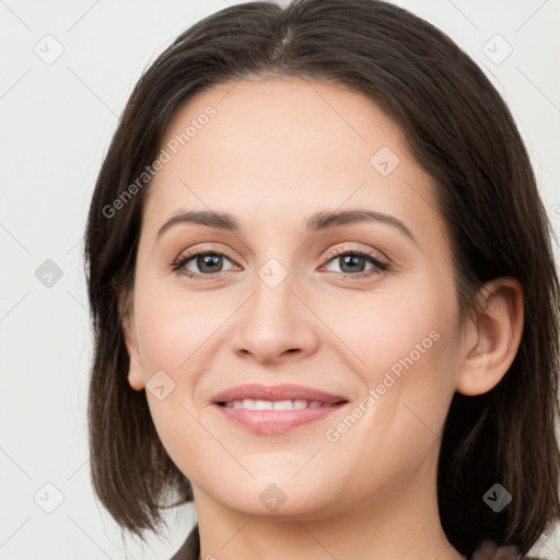 Joyful white young-adult female with medium  brown hair and grey eyes