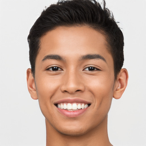 Joyful latino young-adult male with short  brown hair and brown eyes