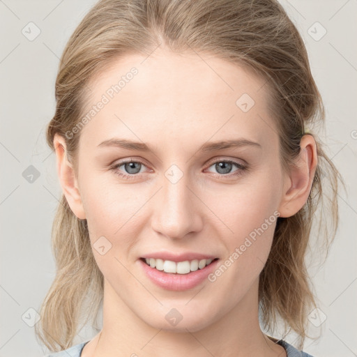 Joyful white young-adult female with medium  brown hair and blue eyes