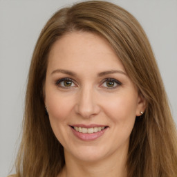 Joyful white young-adult female with long  brown hair and brown eyes