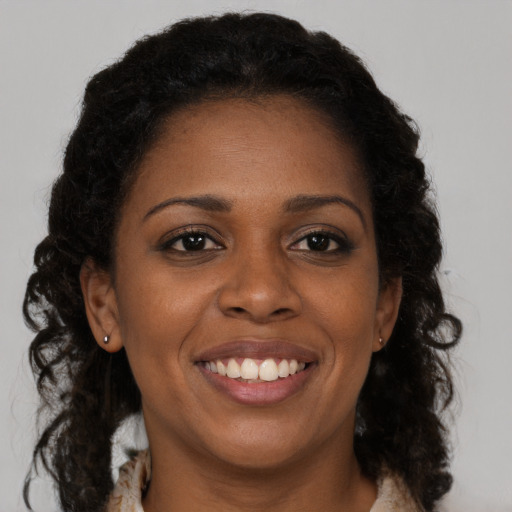Joyful black young-adult female with medium  brown hair and brown eyes