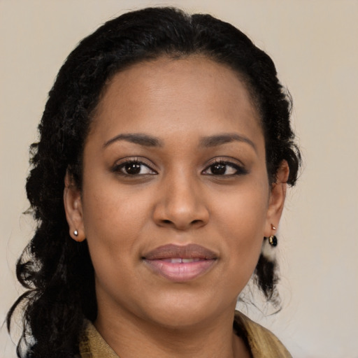 Joyful black young-adult female with long  brown hair and brown eyes