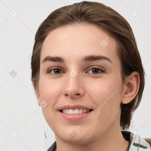 Joyful white young-adult female with medium  brown hair and grey eyes