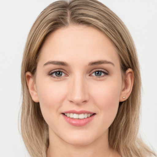 Joyful white young-adult female with long  brown hair and grey eyes