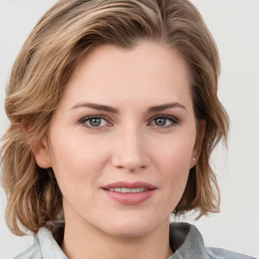 Joyful white young-adult female with medium  brown hair and blue eyes