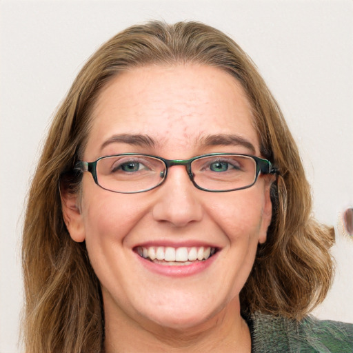 Joyful white adult female with medium  brown hair and green eyes