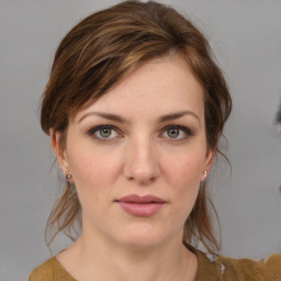 Joyful white young-adult female with medium  brown hair and grey eyes