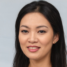 Joyful asian young-adult female with long  brown hair and brown eyes