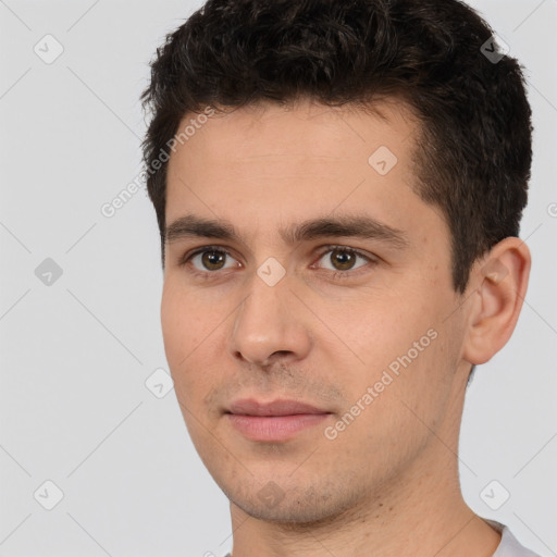 Joyful white young-adult male with short  black hair and brown eyes