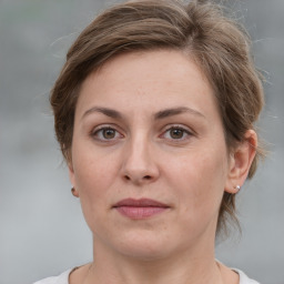 Joyful white adult female with medium  brown hair and grey eyes