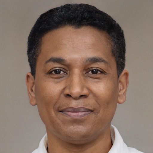 Joyful latino adult male with short  black hair and brown eyes