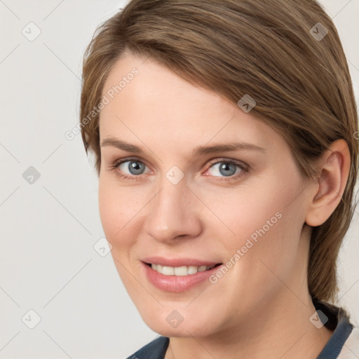 Joyful white young-adult female with medium  brown hair and grey eyes