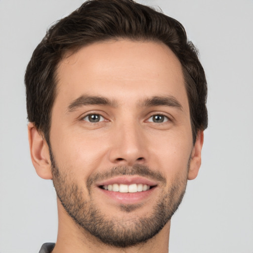 Joyful white young-adult male with short  brown hair and brown eyes