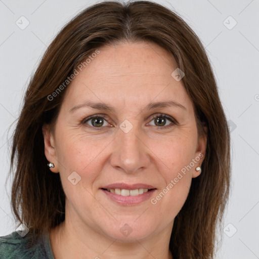 Joyful white adult female with long  brown hair and grey eyes